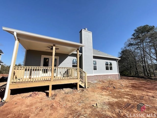 back of property with a wooden deck and ceiling fan