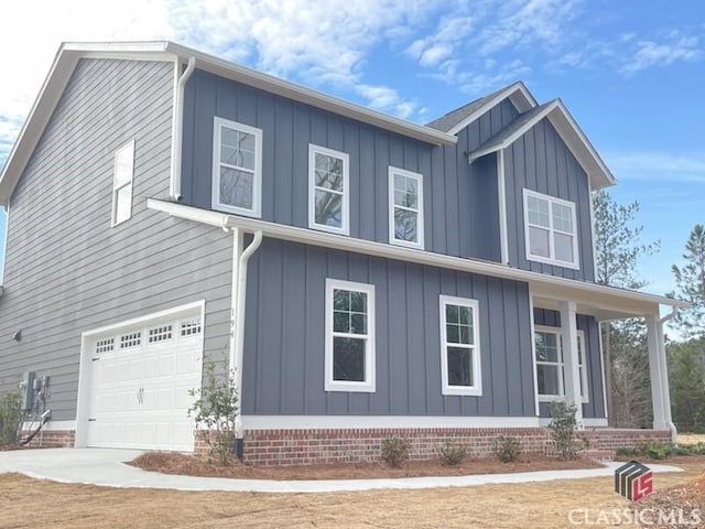 view of side of property with board and batten siding, concrete driveway, and an attached garage