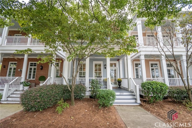 view of front of home featuring a balcony and covered porch