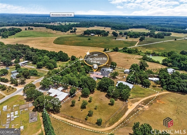 birds eye view of property with a rural view