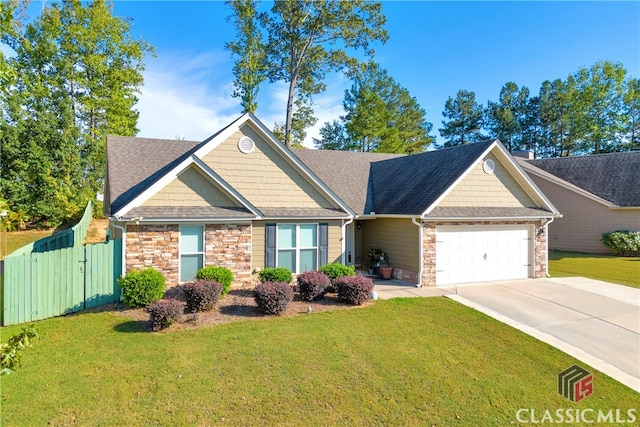 view of front of house featuring a garage and a front lawn