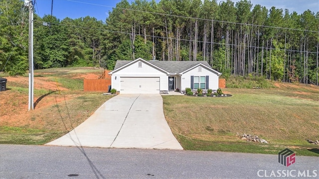 view of front of property with a front yard and a garage