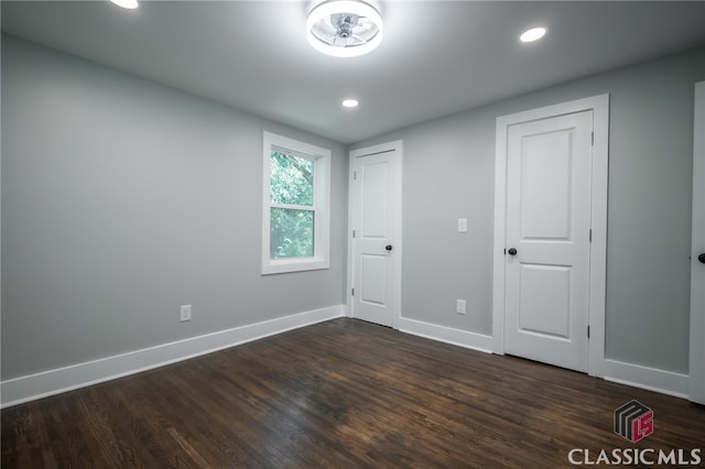 empty room featuring dark hardwood / wood-style flooring