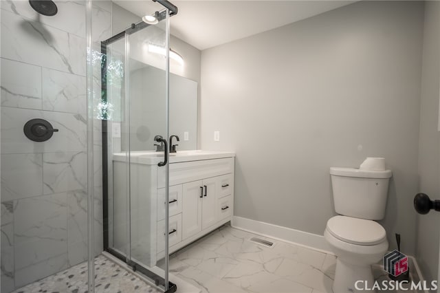 bathroom with vanity, a shower with shower door, and toilet