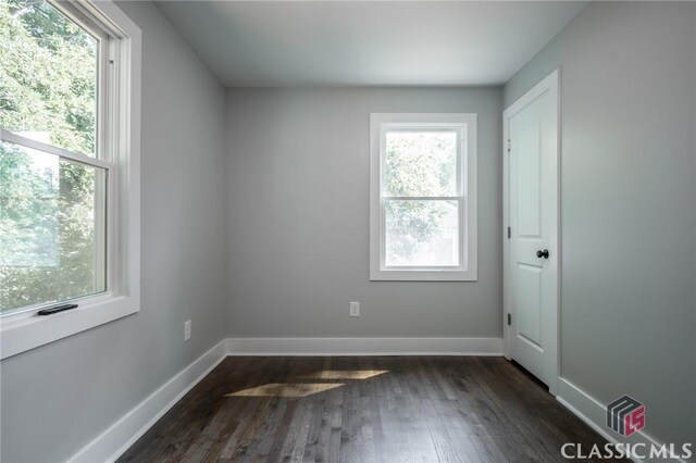 spare room with dark hardwood / wood-style flooring