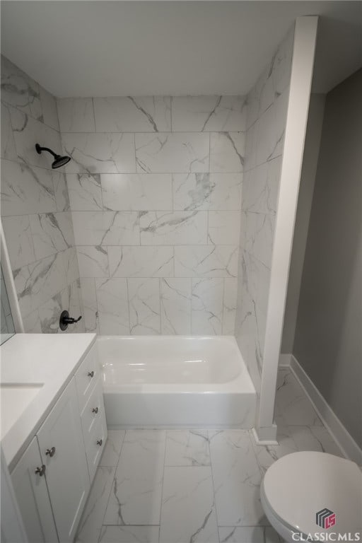 full bathroom featuring vanity, tiled shower / bath combo, and toilet