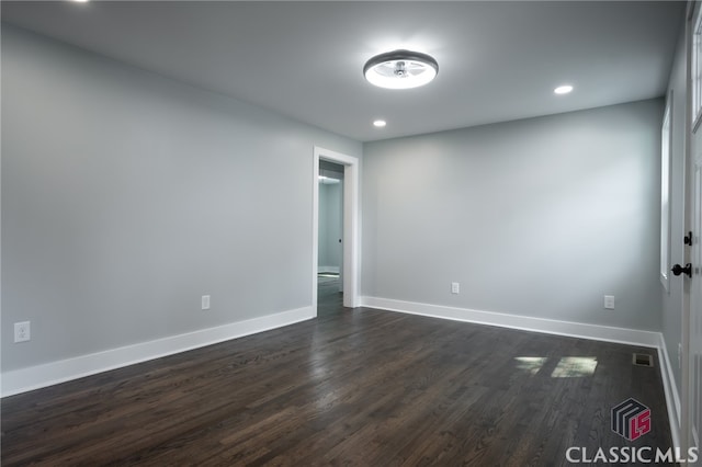 spare room featuring dark wood-type flooring