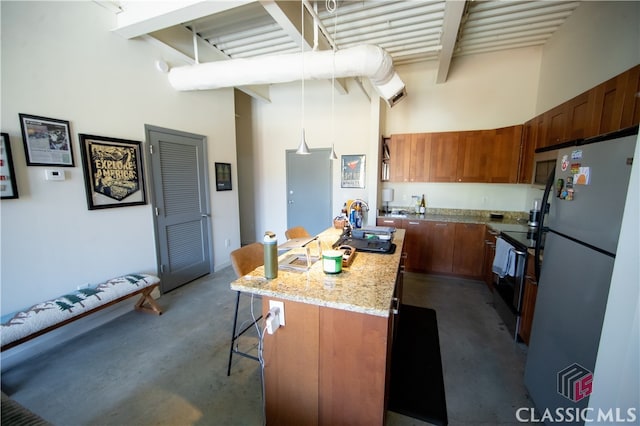 kitchen with black / electric stove, stainless steel refrigerator, a breakfast bar area, beamed ceiling, and a high ceiling