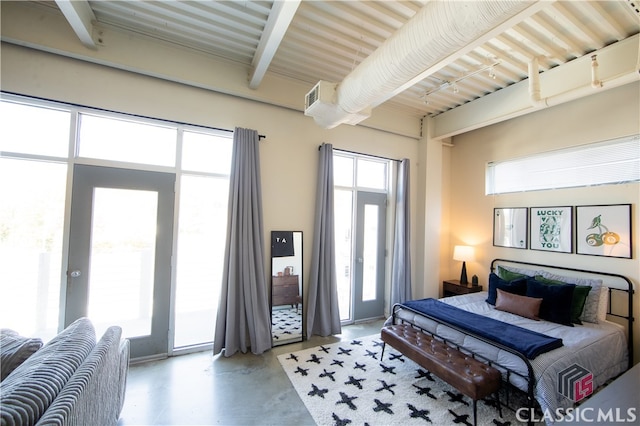 bedroom featuring concrete flooring and access to exterior