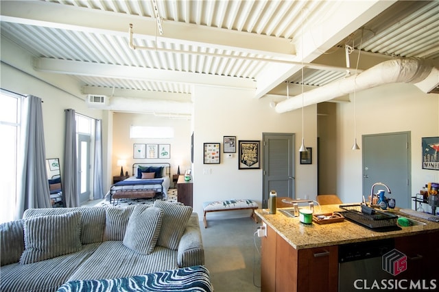 living room featuring beam ceiling and concrete flooring