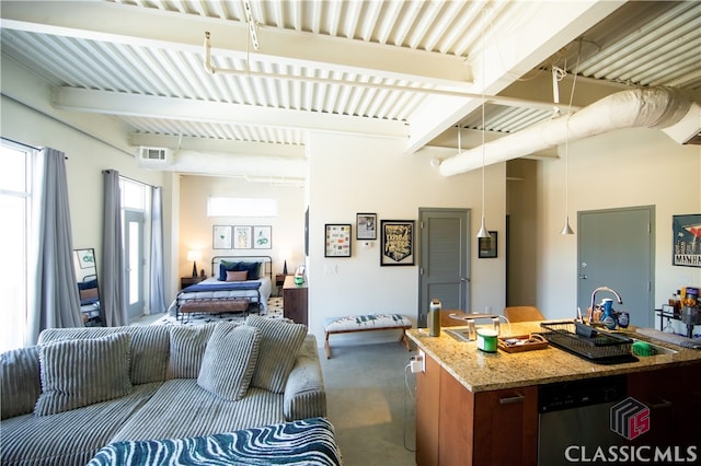 living room featuring concrete flooring and beamed ceiling