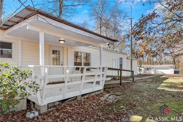 view of side of property with a wooden deck and a porch