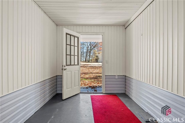 entryway featuring wooden walls