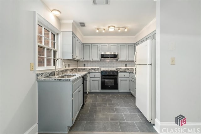 kitchen with gray cabinetry, light stone countertops, sink, and black appliances