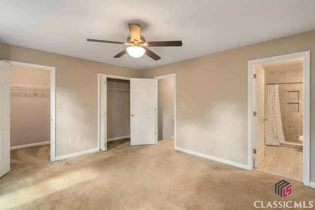 unfurnished bedroom featuring ensuite bathroom, ceiling fan, and light carpet