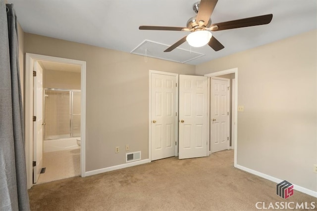 unfurnished bedroom with ceiling fan, light carpet, and ensuite bath