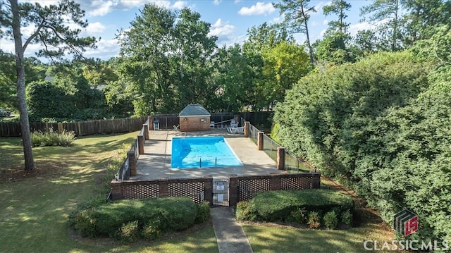 view of pool with a lawn and a patio