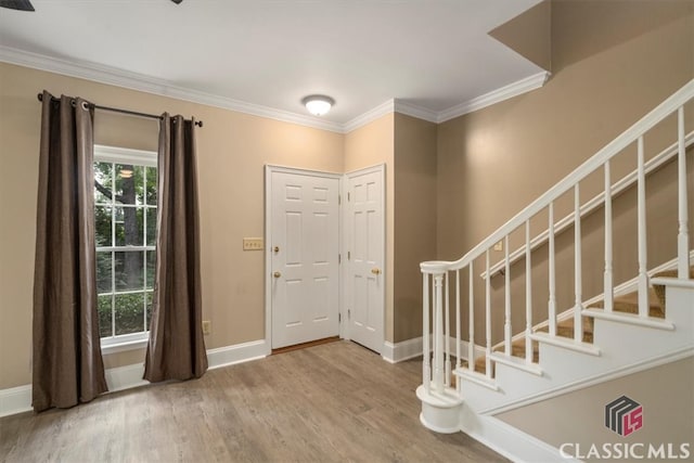 entryway featuring hardwood / wood-style floors and ornamental molding