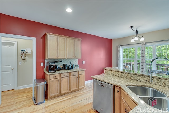 kitchen featuring light hardwood / wood-style floors, dishwasher, decorative light fixtures, sink, and a notable chandelier