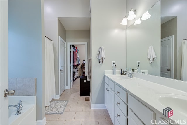 bathroom with vanity, tile patterned flooring, and a bath