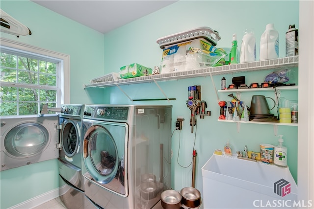 washroom with tile patterned flooring, separate washer and dryer, and sink