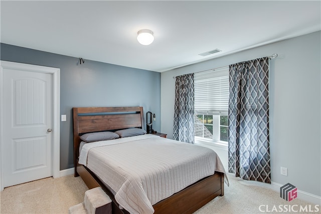 bedroom with light colored carpet