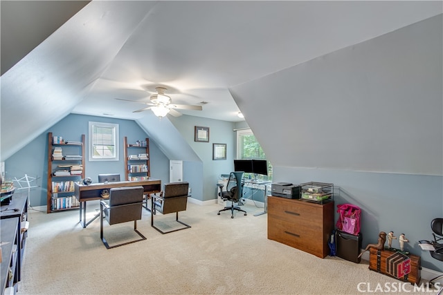 carpeted office featuring lofted ceiling and ceiling fan