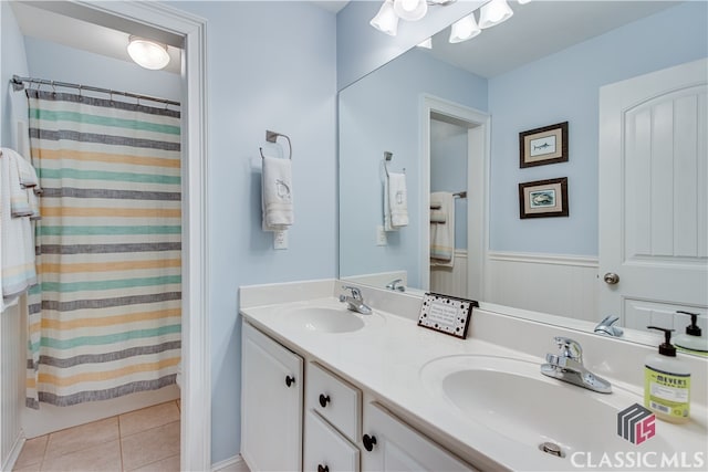 bathroom featuring tile patterned flooring, vanity, and a shower with shower curtain