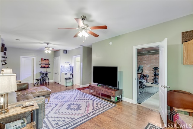 living room with ceiling fan and light hardwood / wood-style floors