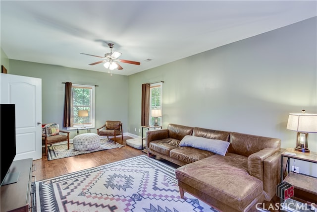 living room with hardwood / wood-style floors and ceiling fan