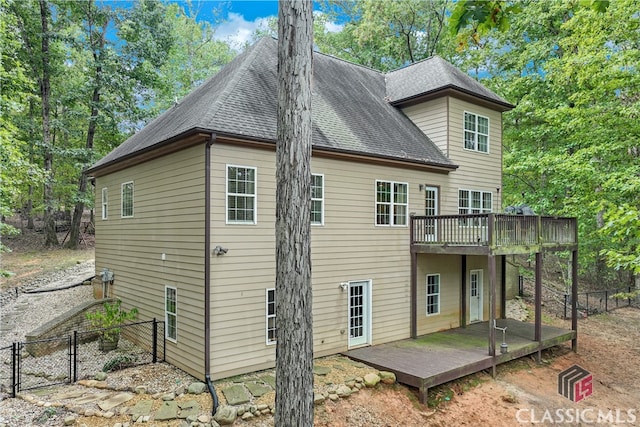 rear view of property featuring a deck