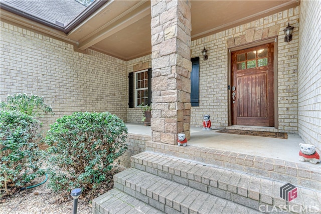 view of exterior entry featuring covered porch