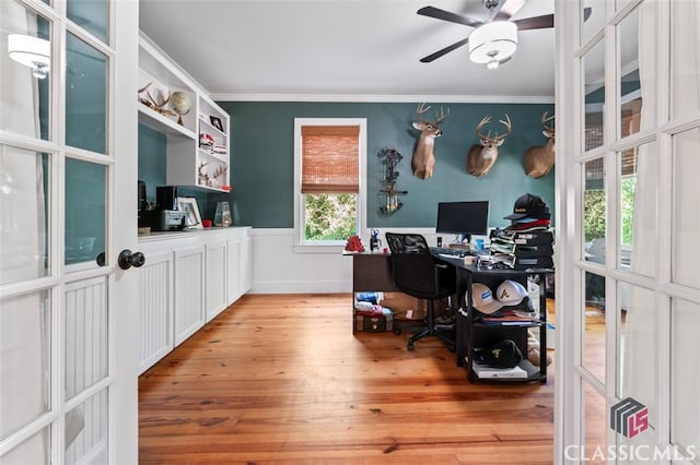 office featuring light hardwood / wood-style floors, ceiling fan, and crown molding