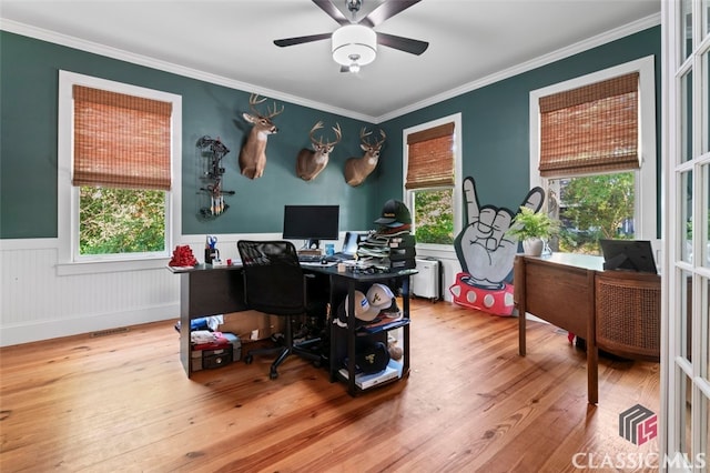 home office with ceiling fan, hardwood / wood-style flooring, a healthy amount of sunlight, and crown molding