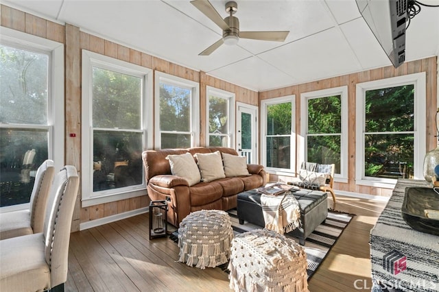 sunroom / solarium featuring ceiling fan