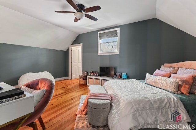 bedroom featuring ceiling fan, vaulted ceiling, and light hardwood / wood-style floors