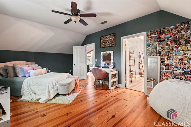 bedroom featuring wood-type flooring, lofted ceiling, and ceiling fan