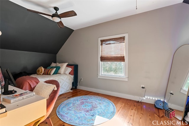 bedroom featuring ceiling fan, vaulted ceiling, and hardwood / wood-style floors