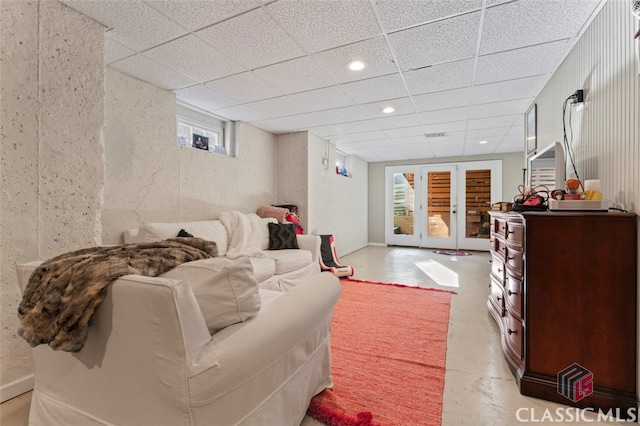 living room with french doors and a drop ceiling