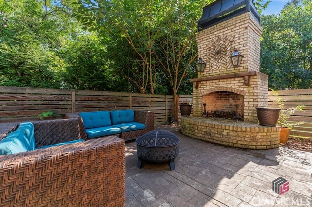 view of patio / terrace featuring an outdoor living space with a fireplace