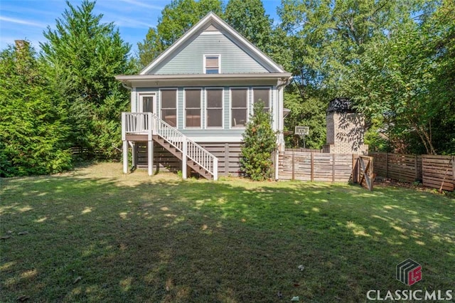 back of property featuring a sunroom and a yard