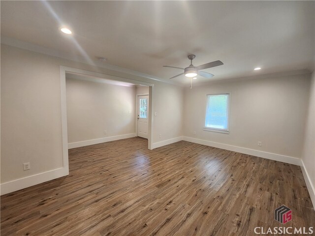 spare room with ornamental molding, dark hardwood / wood-style flooring, and ceiling fan