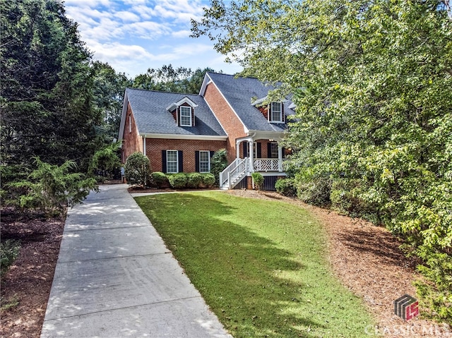 cape cod home with a front yard