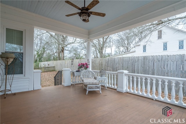 unfurnished living room with ceiling fan, hardwood / wood-style flooring, a fireplace, and crown molding