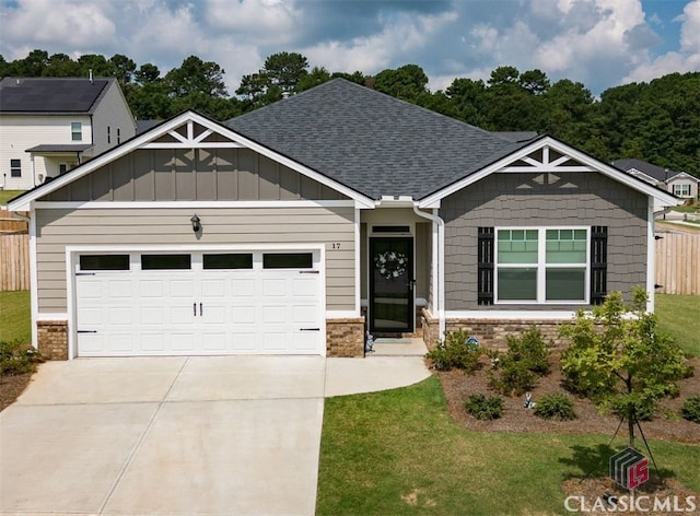 craftsman inspired home featuring a garage and a front yard