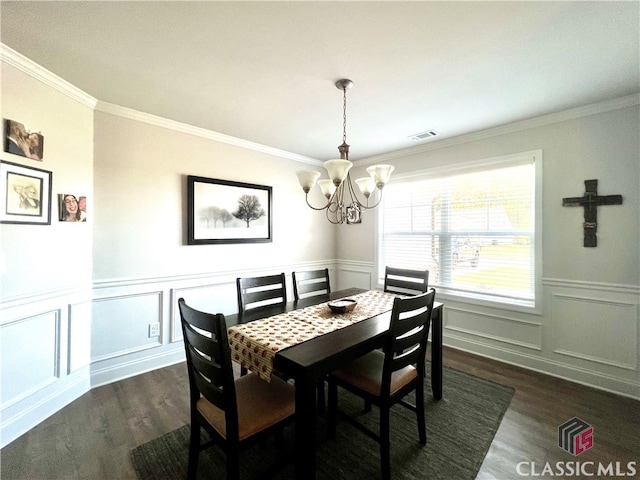 dining room with crown molding, dark hardwood / wood-style floors, and a notable chandelier