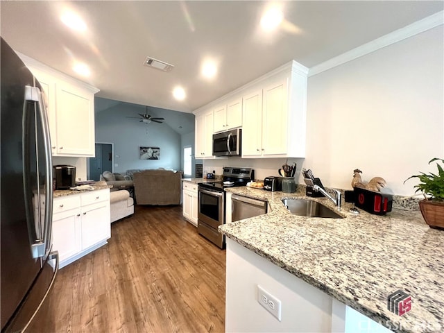 kitchen featuring stainless steel appliances, sink, white cabinets, and kitchen peninsula