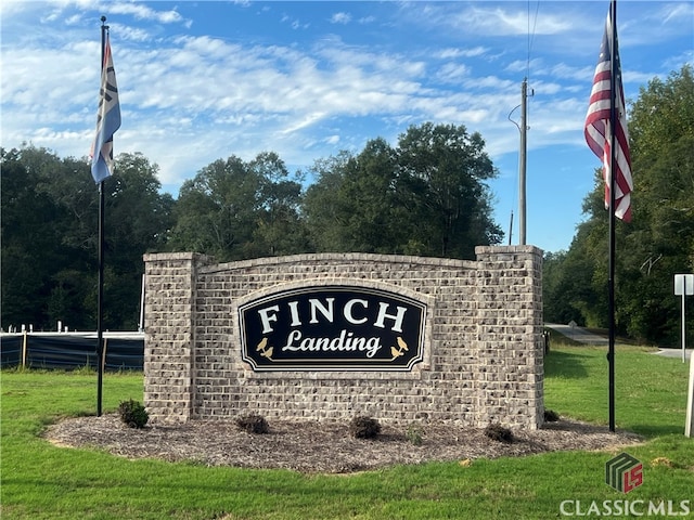 community sign featuring a lawn