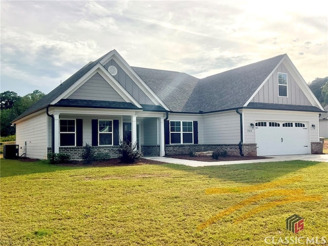 craftsman-style home featuring central AC unit, a garage, and a front lawn