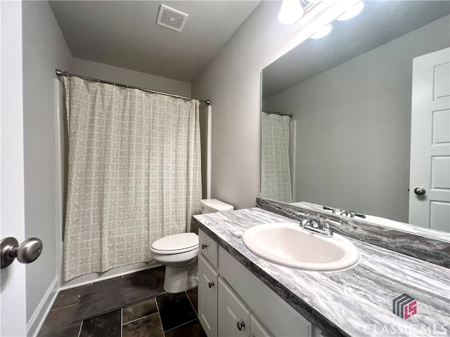 bathroom featuring vanity and toilet